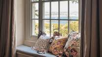 This quaint window seat is the perfect place to settle and watch the gentle lap of waves