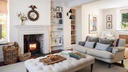 The pretty sitting room with a charming wood burner is a perfectly peaceful spot to unwind