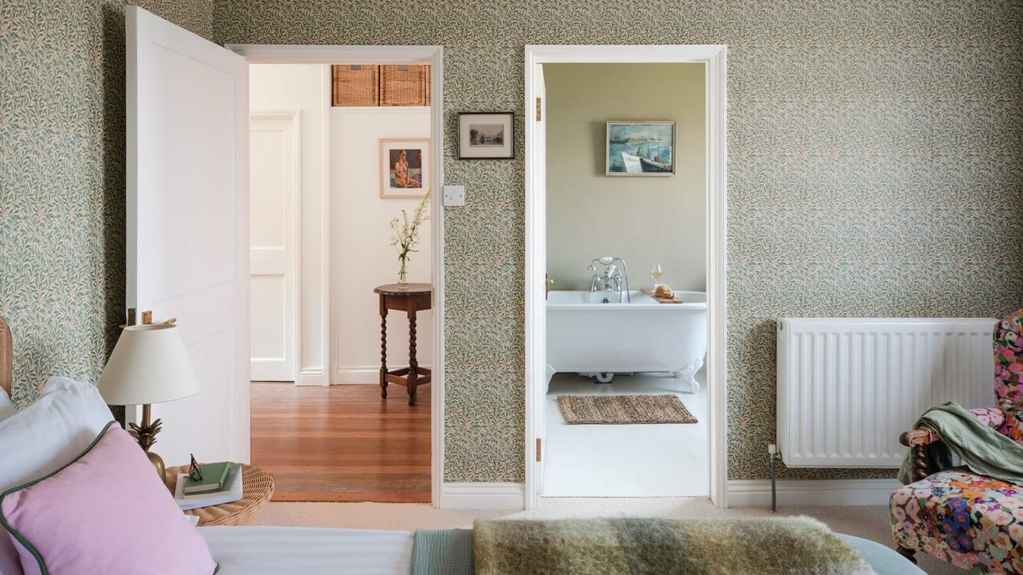 Across the hall you'll find a stunning bedroom with charming William Morris wallpaper on every wall