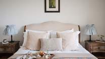 Blissful slumbers amongst luxurious linens await in the king sized sleigh-style bed