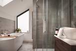 The en suite with decadent bath tub for two and separate shower