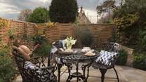 To the front of Burghope you'll find a lovely sunny spot with table and chairs and lots of lush planting