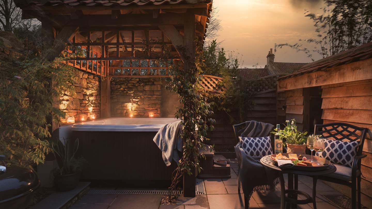 To the back of the garden lies the jacuzzi hot tub tucked under an oak gazebo