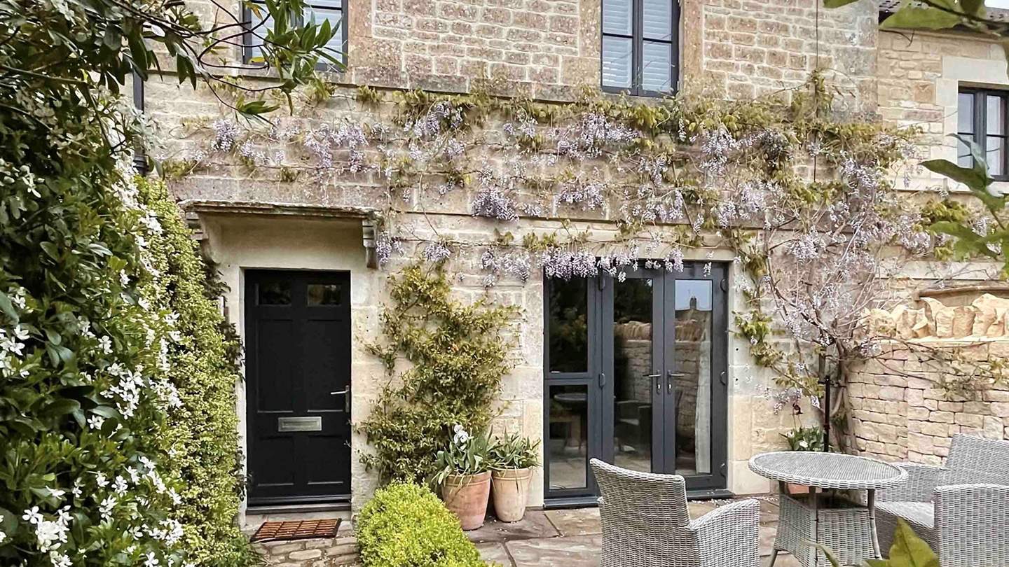 Enchanting wisteria adorns the exterior of our darling abode
