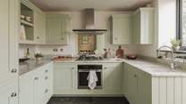 The gorgeous green bespoke kitchen has everything you need to rustle up your favourite feasts