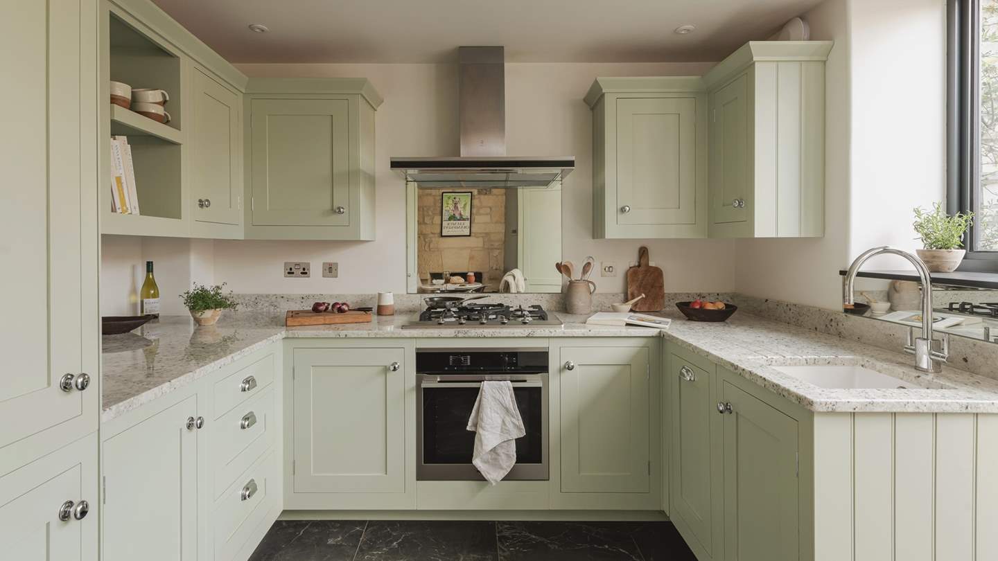 The gorgeous green bespoke kitchen has everything you need to rustle up your favourite feasts