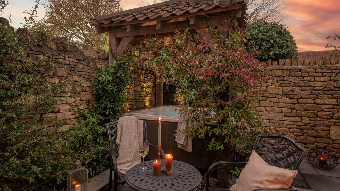 To the back of the garden lies the jacuzzi hot tub tucked under an oak gazebo