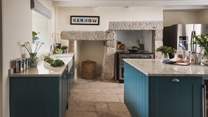 Grand and gorgeous, this country kitchen features hints of rich turquoise; the ultimate balance of modern and rustic décor