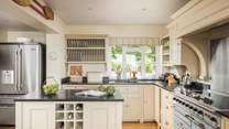 The open-plan kitchen has everything you'll need, from the Aga fridge to the Nespresso machine. 