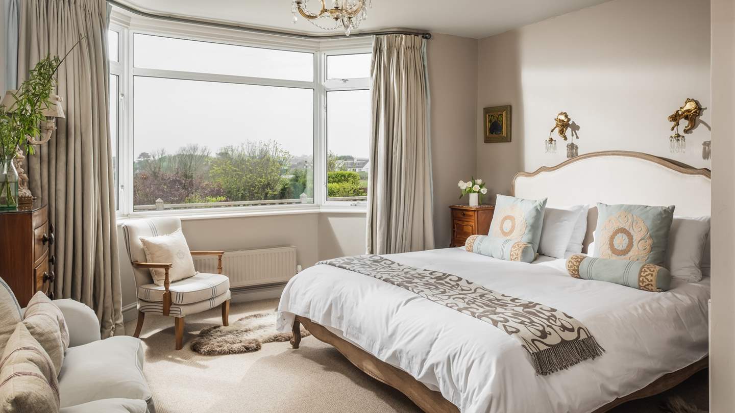 The incredibly romantic master bedroom has a king-sized Feather and Black Sienna bed, sea views and an en suite wet room.