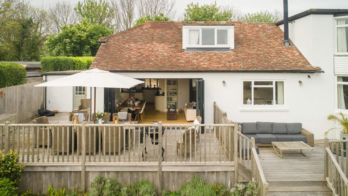 During warmer months, huge bi-fold doors open out to the large sun-soaked terrace bringing the outside in.