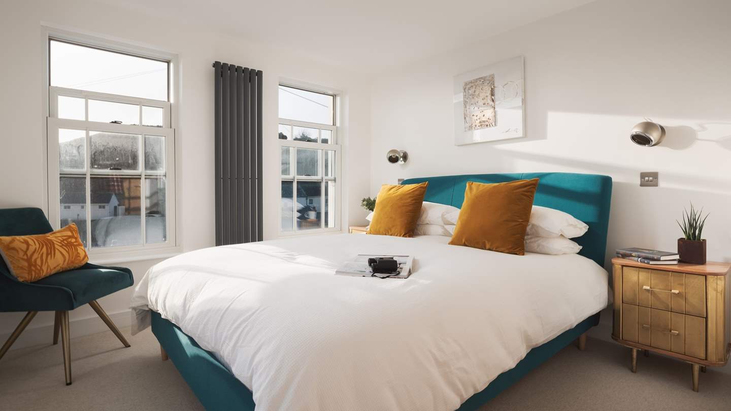 The master bedroom is a beautifully bright, light and tranquil room boasting three windows, all with sea views