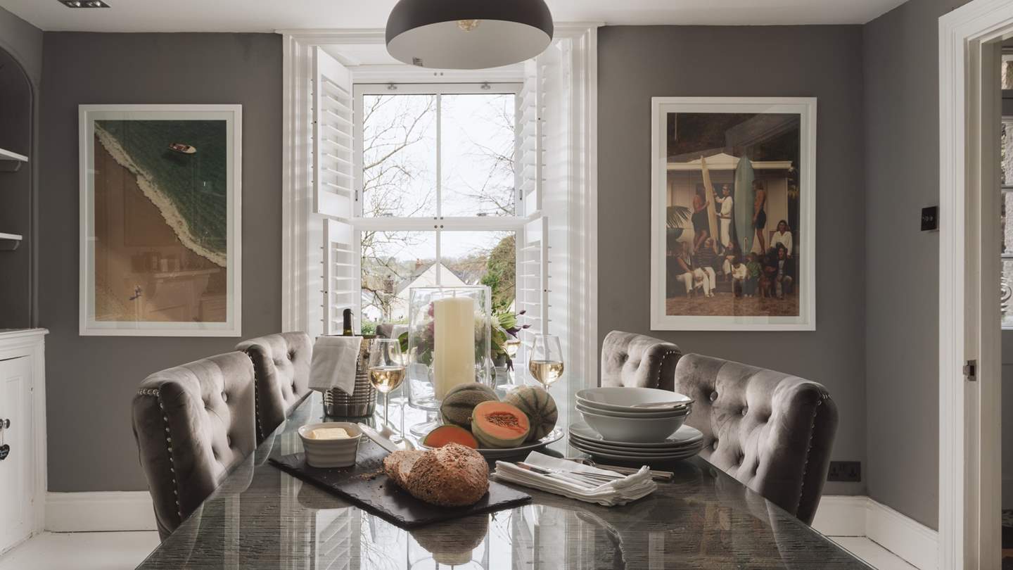 The formal dining room is just lovely with a table and beautiful grey velvet chairs