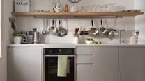 In the kitchen there's There's an electric oven with induction hob, fridge, dishwasher, butler's sink and all the cooking equipment you'll need