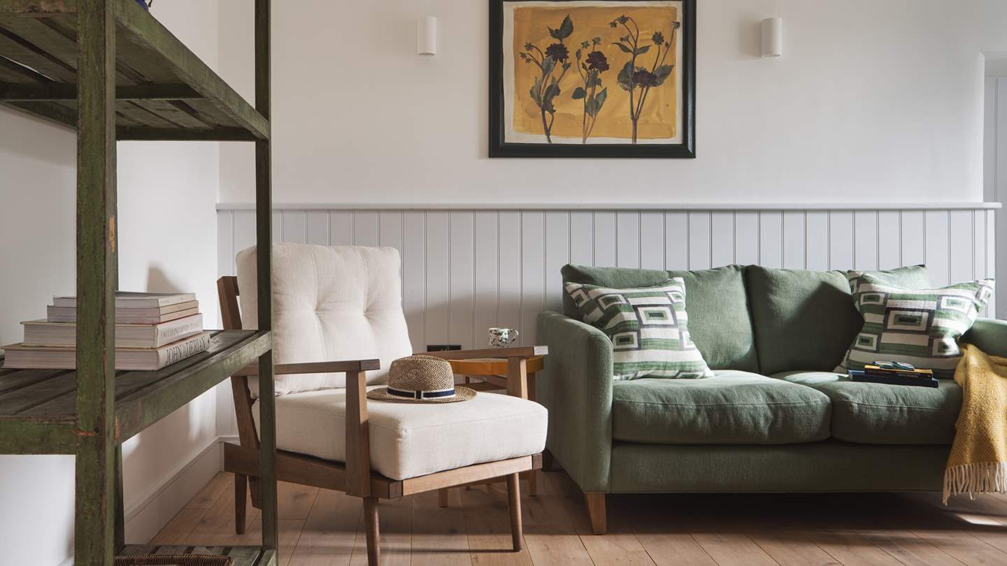 The cosy green sofa is made for curling up on with a good book