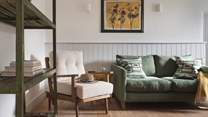 The cosy green sofa is made for curling up on with a good book