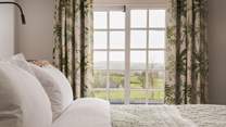 Pretty countryside views can be gazed at from the comfort of your bed