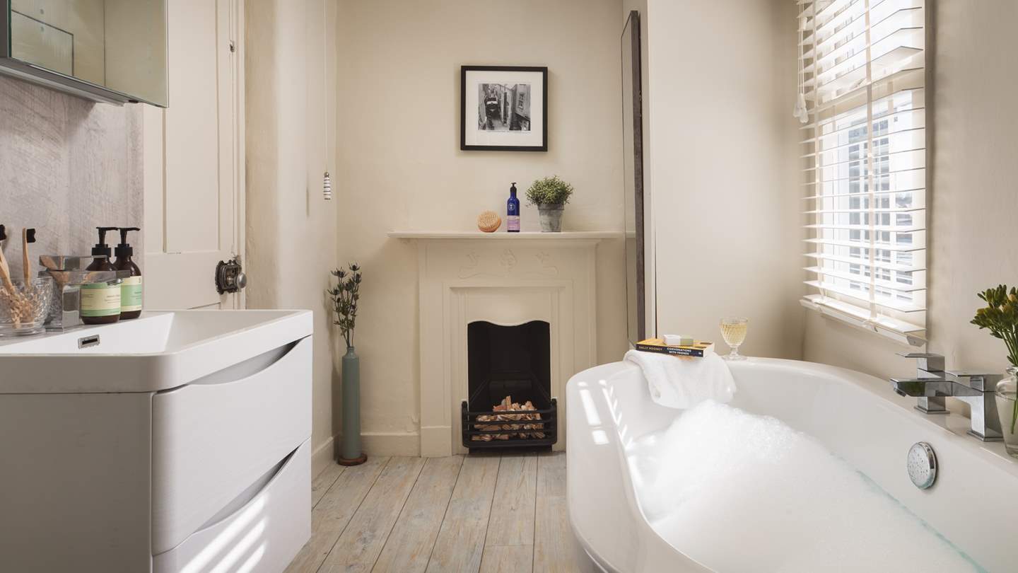 The oh-so-romantic bathroom has a delightful bathtub for two