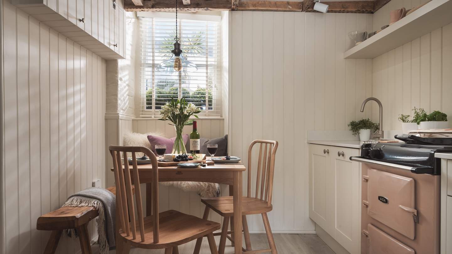 The dining table sits close by and easily seats four people and can be extended to eat eight