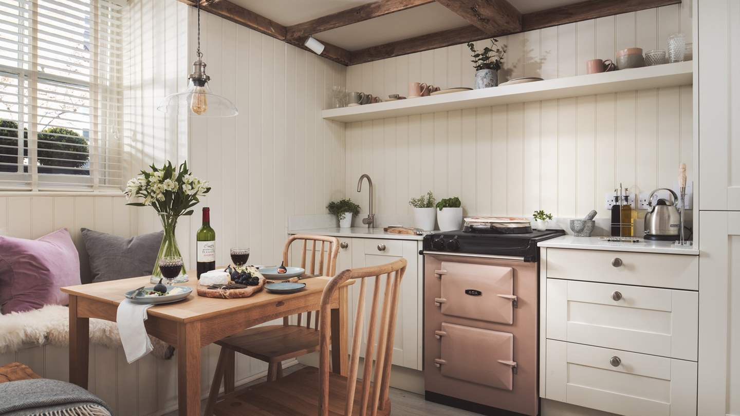 With a cute dusky pink Aga to match, the kitchen has everything you need to rustle up snacks and meals