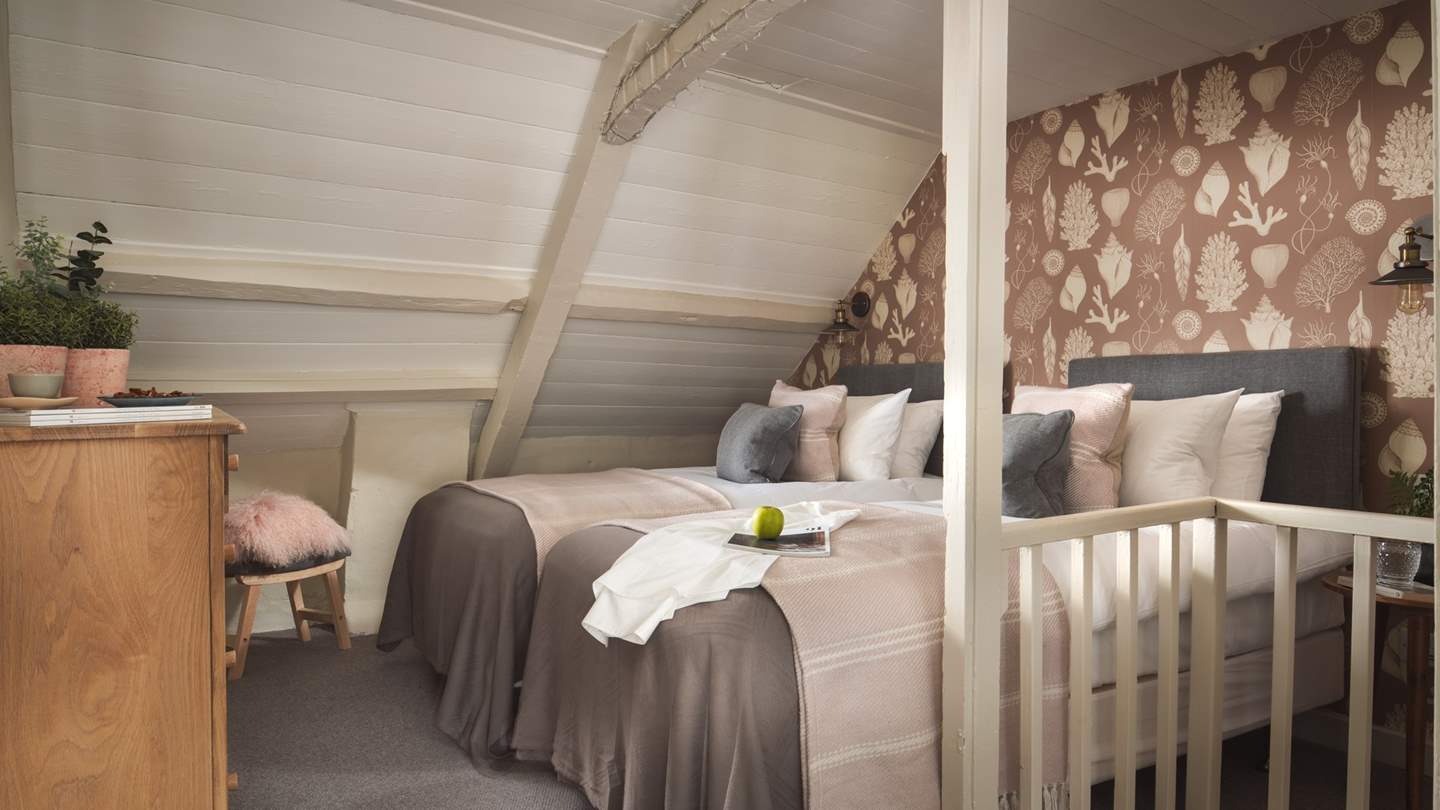 On the top floor, amongst the eaves, lies the second bedroom 