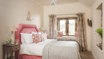 'Pippin' is an oh-so-sweet cosy king size bedroom in shades of red and cream