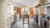 A proper English country kitchen, it boasts both a large four door Aga and an induction range cooker