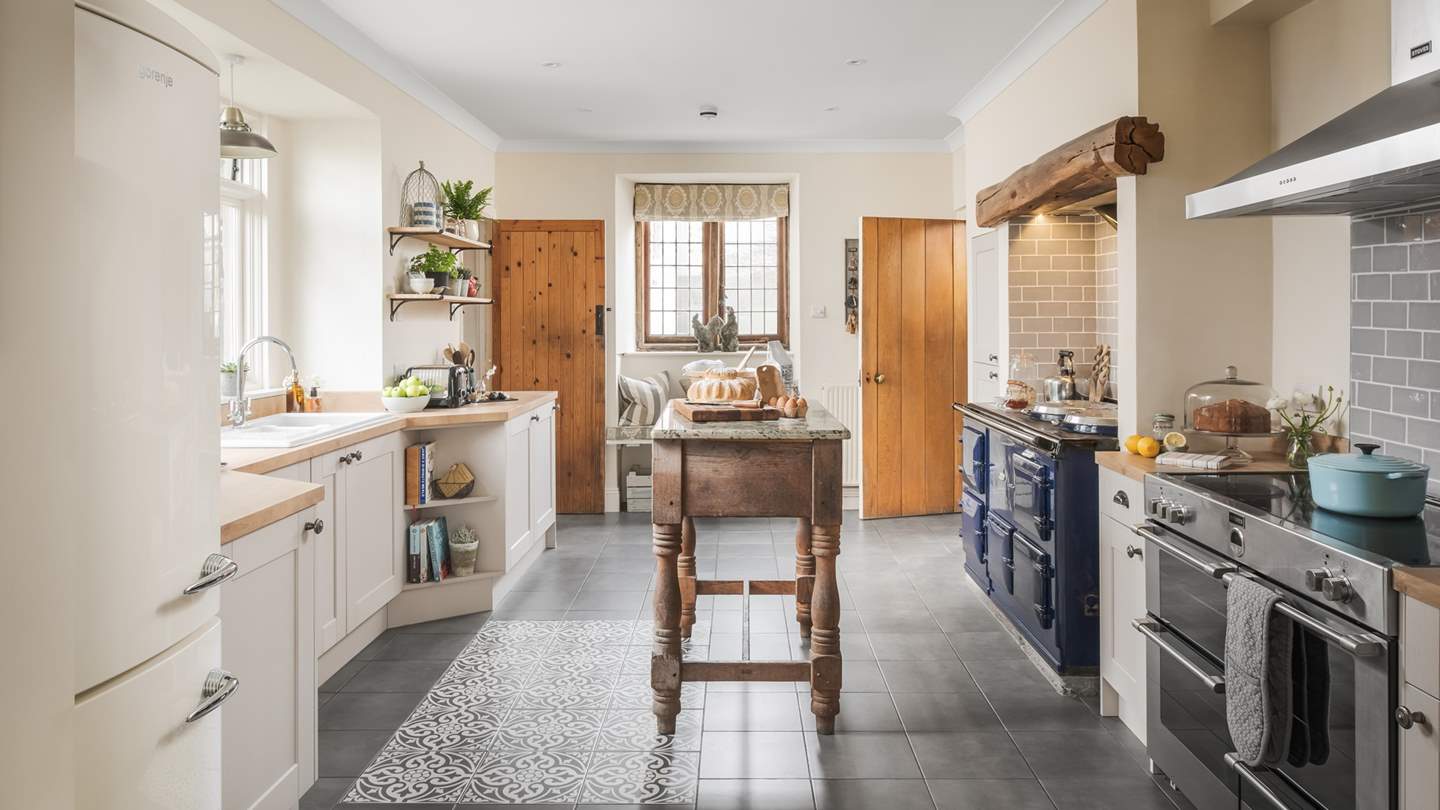 A proper English country kitchen, it boasts both a large four door Aga and an induction range cooker