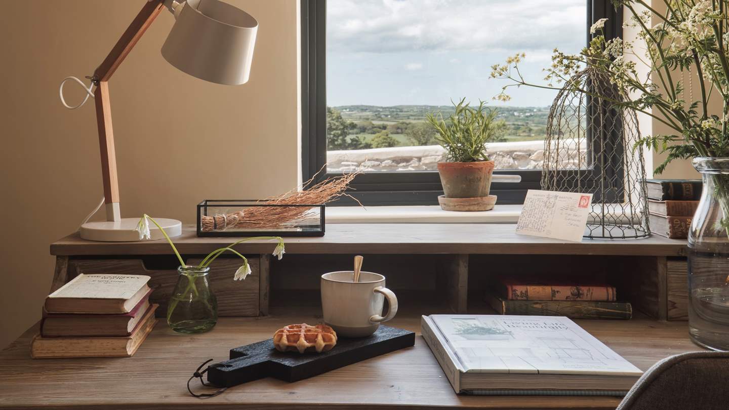 The study has a Loaf desk perfectly placed beneath the mystical window view over lush rolling field