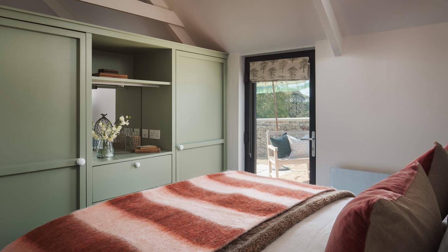 Step out onto the adjacent patio where you’ll find a table and chairs, an idyllic spot for taking your morning coffee into nature