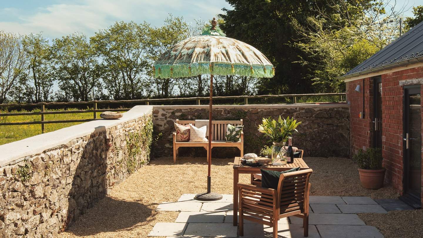 Our charming little cottage overlooks a rolling meadow, with a country chic seating area