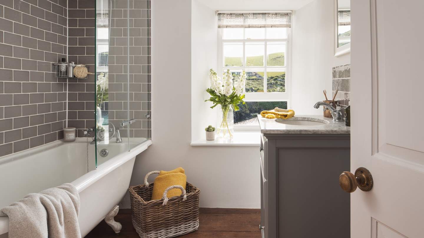 We just love the dark wooden floorboards, marble sink and of course those stunning sea views!