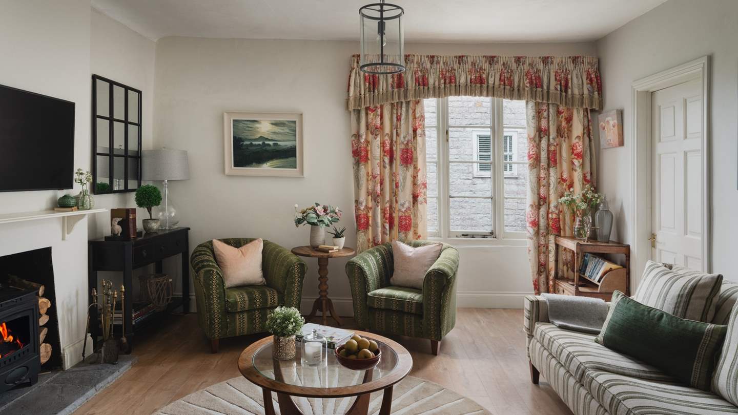 Soft greens, earthy tones and golden-hued wooden floor makes this a peaceful, calming room to retreat 