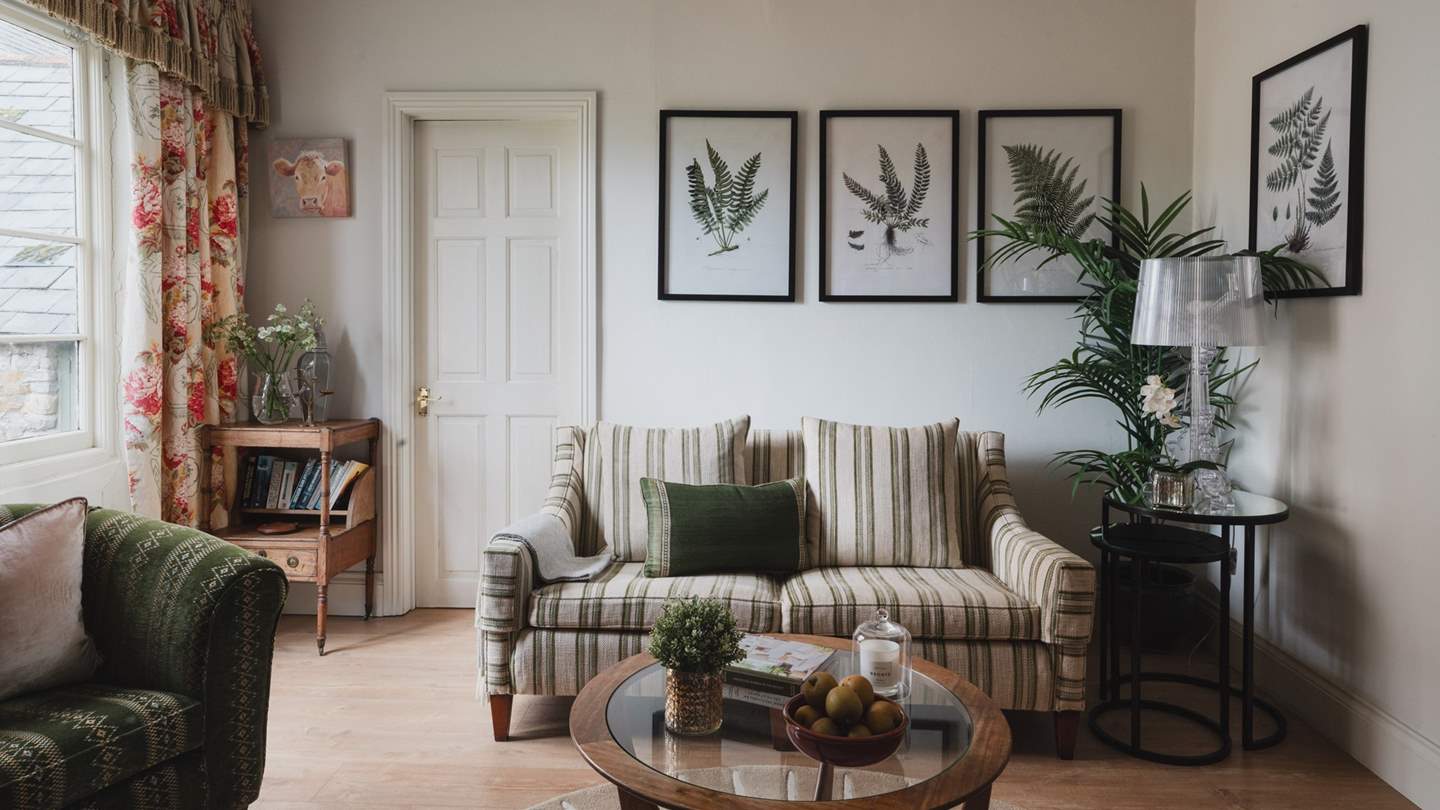 The sumptuous sitting room is just a delight, offering deep, blissful seating to curl up in, whether it's by the crackling wood burner during cooler months or escaping the heat of the day in summer