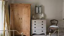 A pine wardrobe and chest of drawers, offer plenty of space to stow away your treasured belongings 