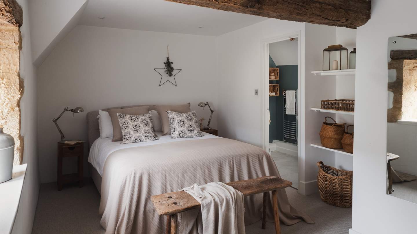 Enswathing the bed are the finest linens and super-soft pillows and throws