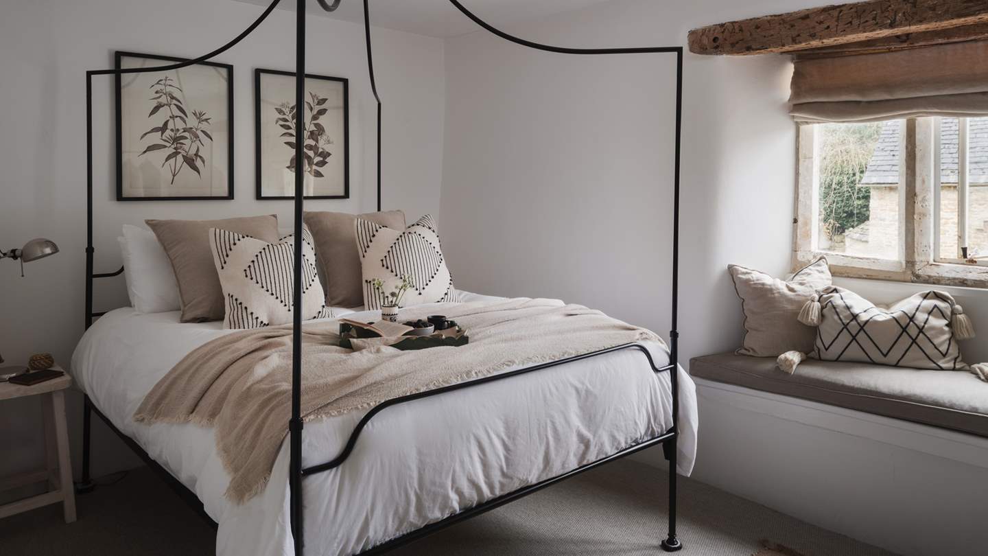 The oh-so-romantic second bedroom is just divine with a White Company king size four-poster bed