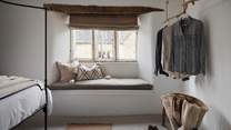 With a cute window seat and gorgeous rustic hanging space