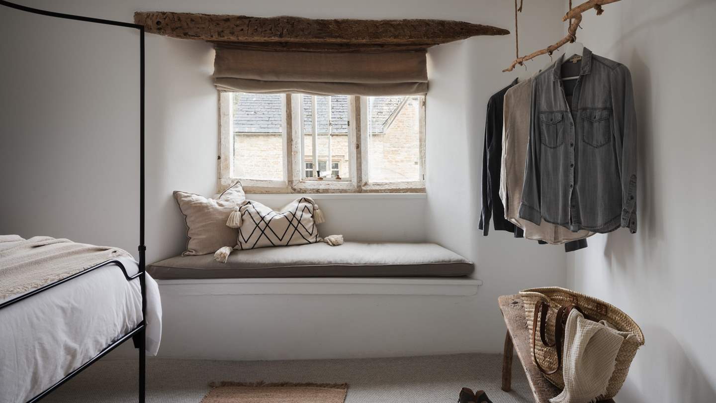 With a cute window seat and gorgeous rustic hanging space