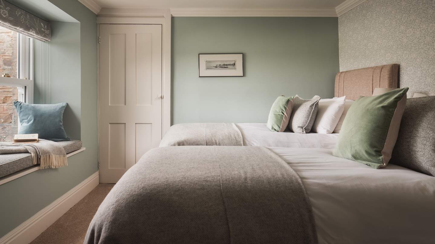 We just love the super-cute window seat in this twin bedroom