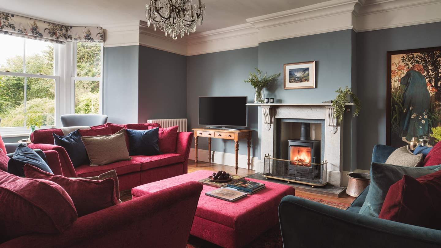 Just wow! The stunning sitting room in jewel tones is the perfect setting for ultimate relaxation around the wood burner