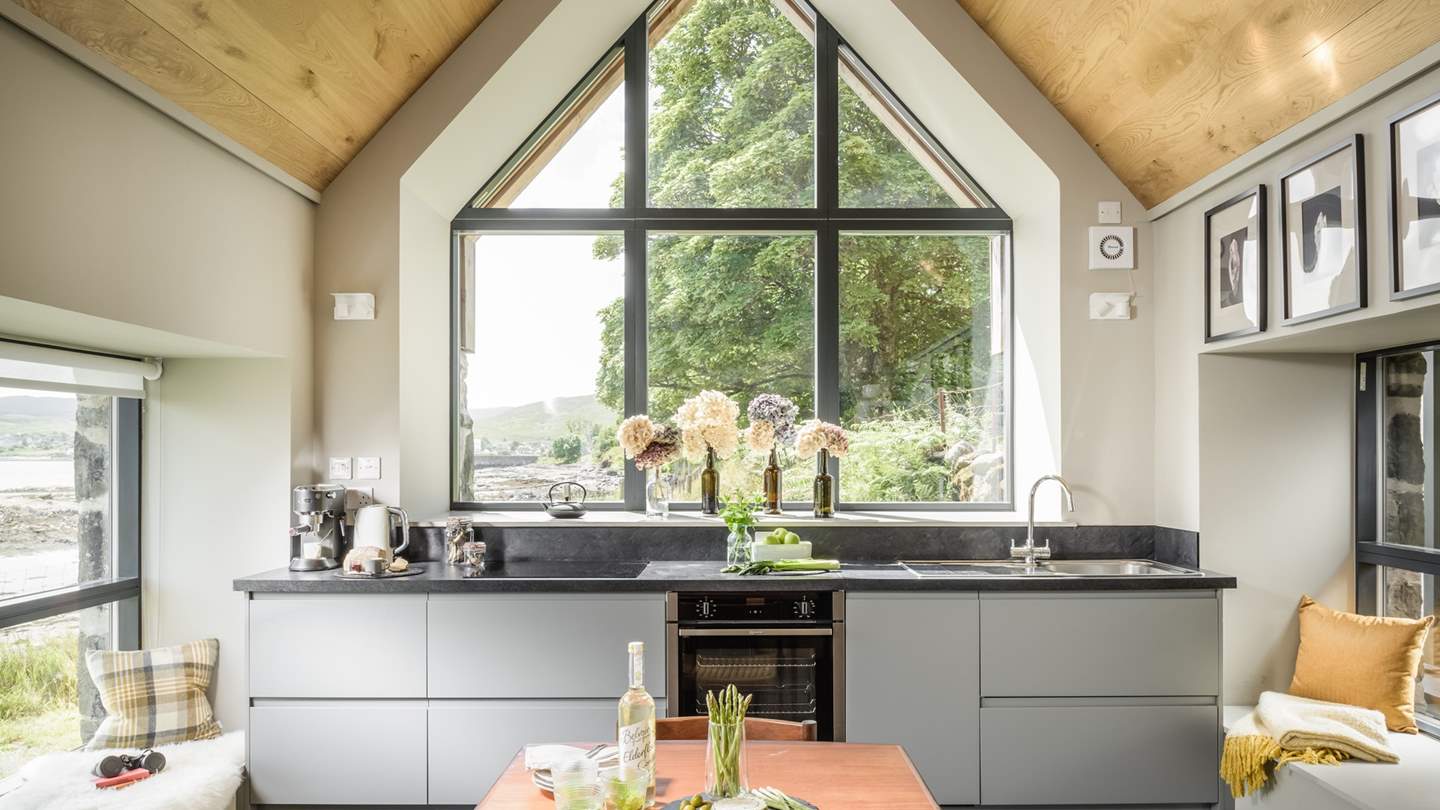 The huge windows, exposed stone walls and high wooden vaulted ceiling makes this spot the heart of the home