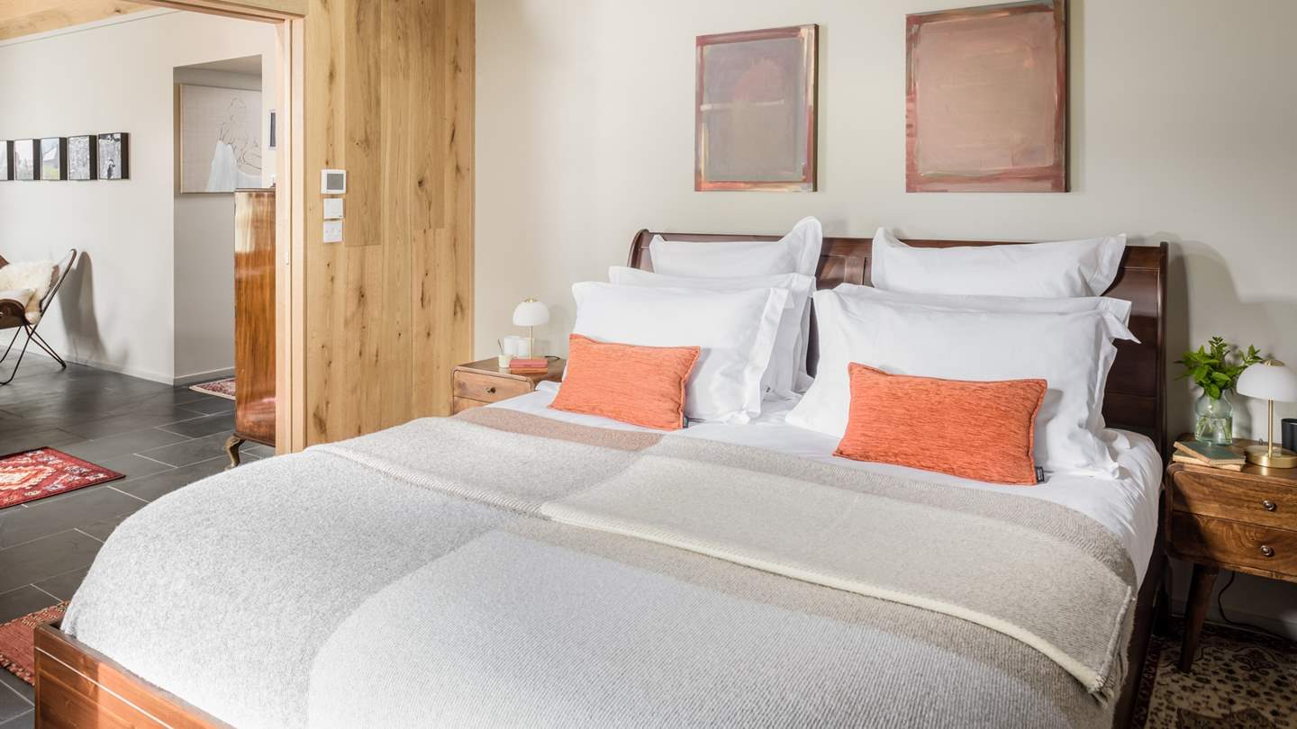 The bedroom is adorned with a stunning wooden super king sleigh bed - bliss! 