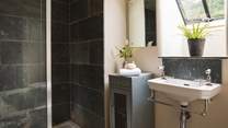 Rejuvenating showers await in the charcoal grey shower room