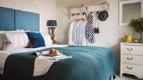 The master bedroom is just delightful in pale, natural colours offset by the beautiful teal velvet super king-sized bed