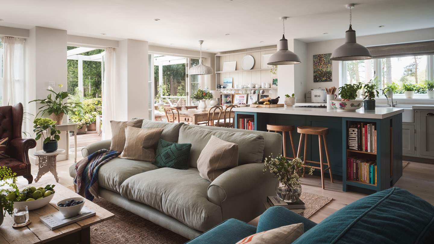 The gorgeous, light-filled sitting area has two super-comfy Loaf sofas and a leather Chesterfield armchair 