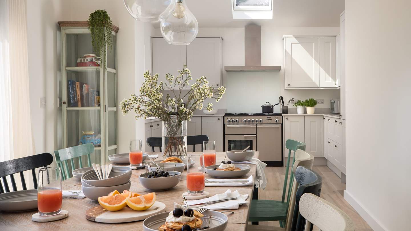 Beautifully light and airy in pale colours, the kitchen benefits from floor to ceiling glass doors which open on to the back garden 