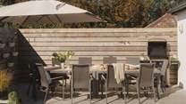 To the back, there's a fabulous table with seating for ten and a Weber gas barbeque - perfect for alfresco moments
