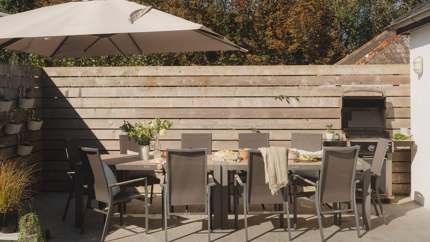 To the back, there's a fabulous table with seating for ten and a Weber gas barbeque - perfect for alfresco moments