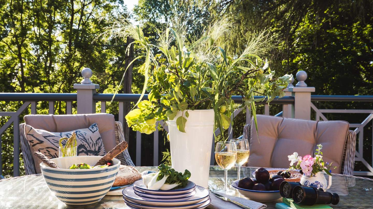 Leading from the kitchen is a vast deck area complete with a dining table and chairs with umbrella 